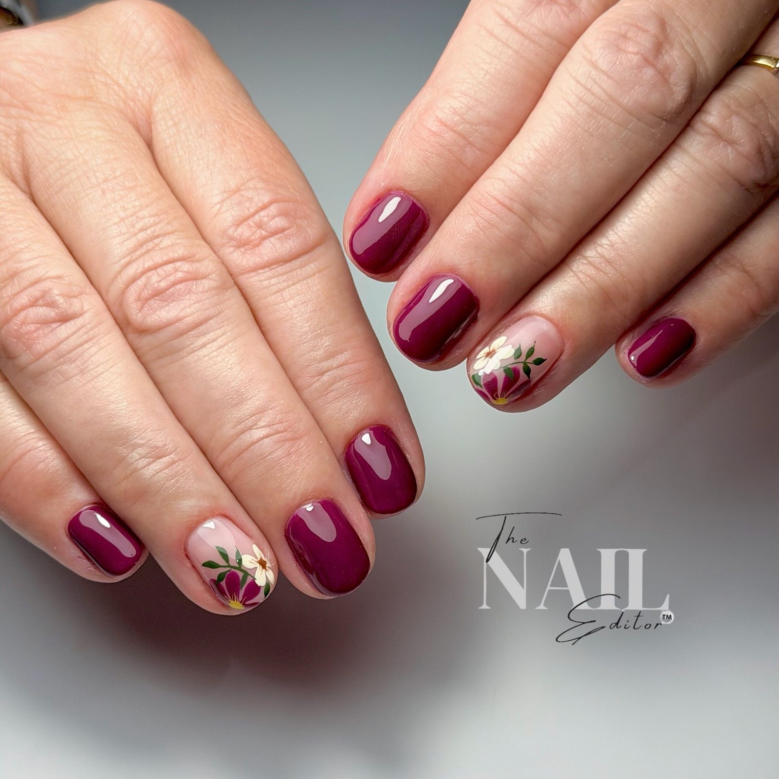 Short Burgundy Nails with Gold and Floral Accent Nails