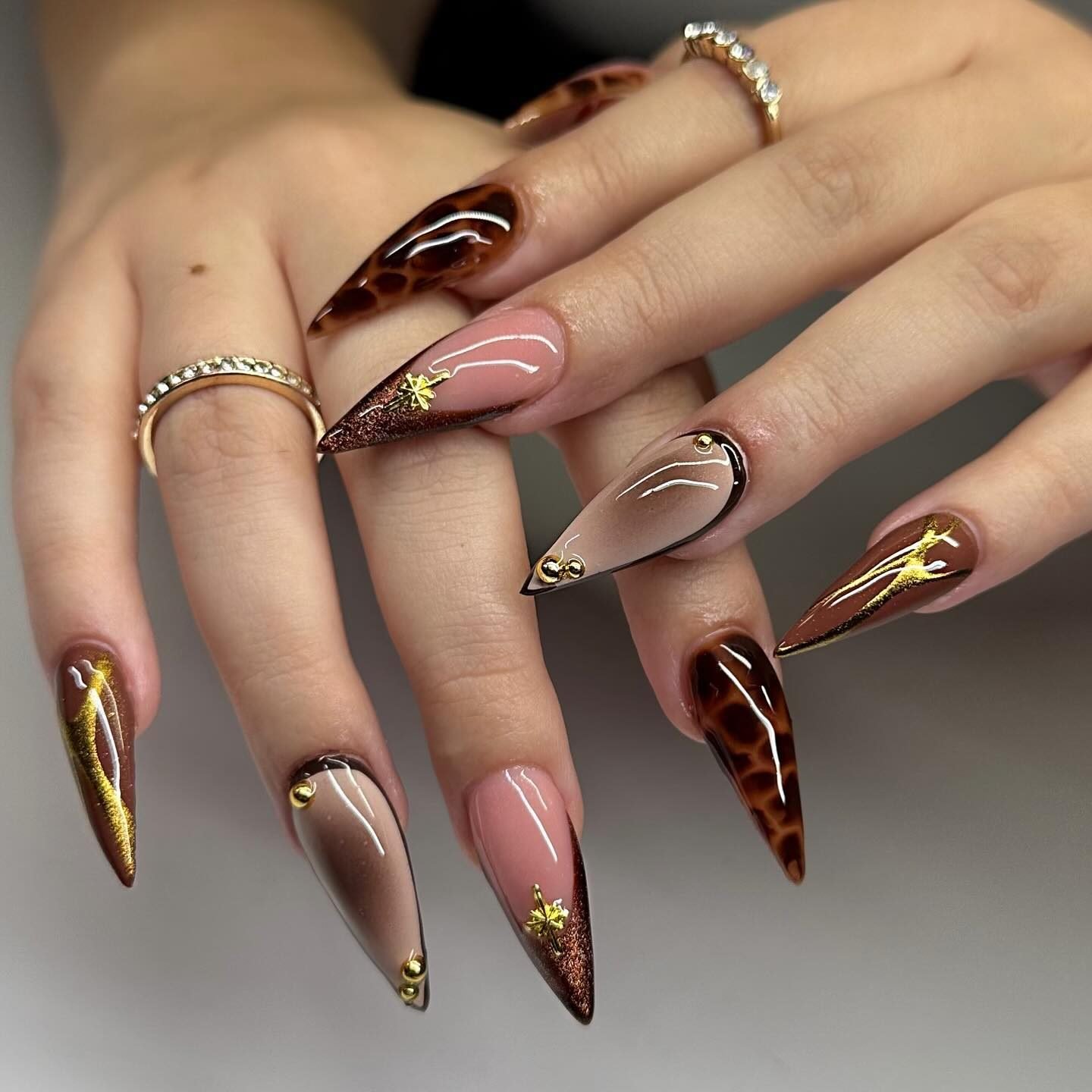 Long Almond Nails with Burgundy, Nude, and Gold-Toned Details