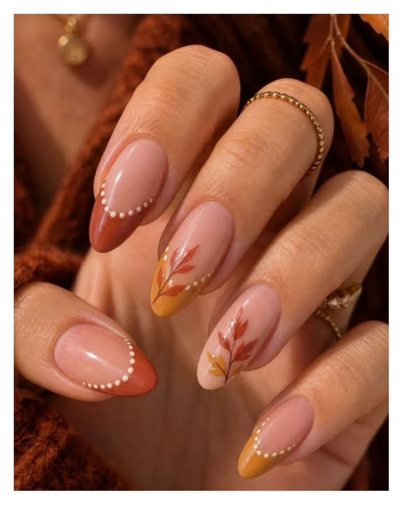 Soft Nude Almond Nails with Brown French Tips and Fine White Dots