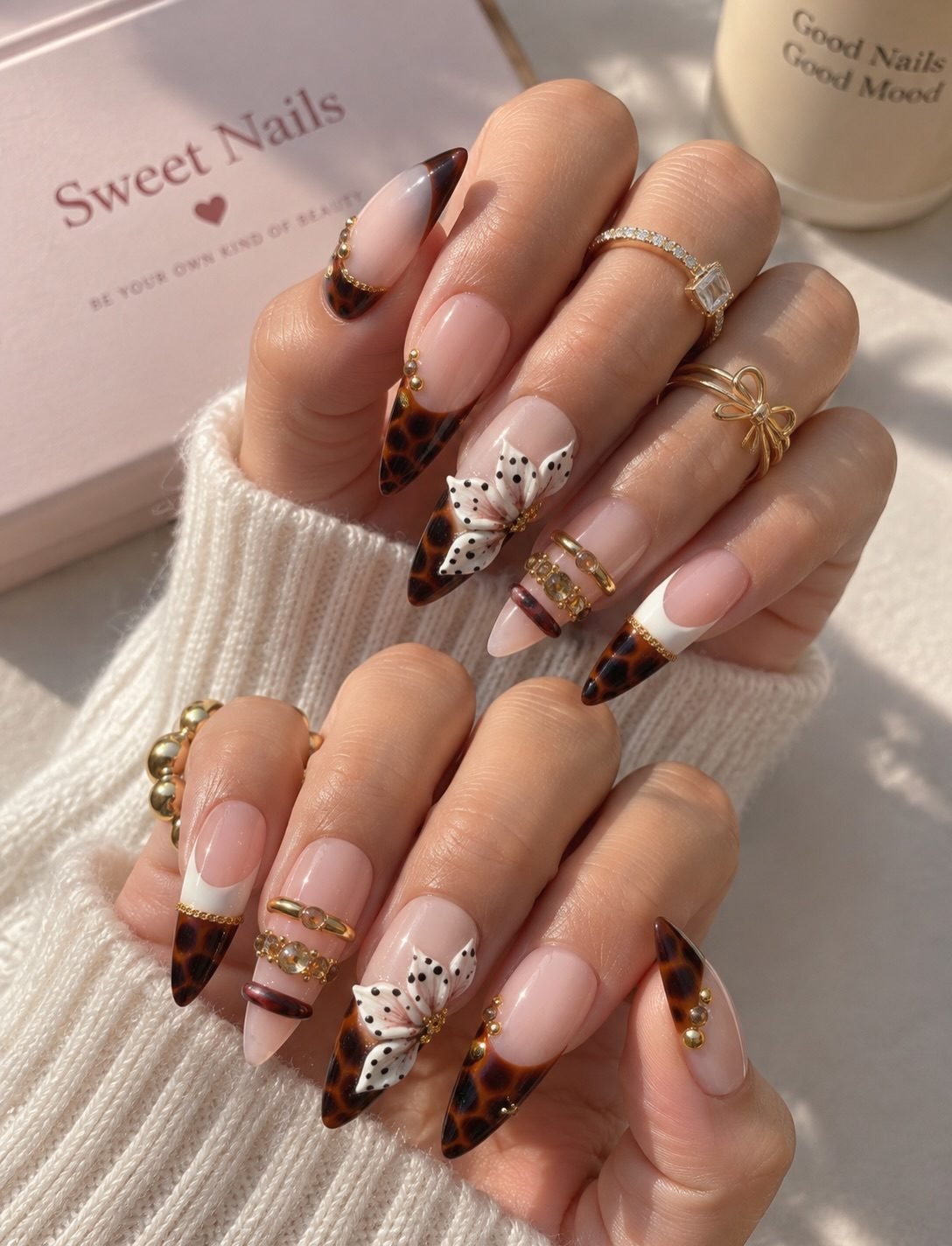 Long Nude and Brown Nails with Gold and Glitter Accents