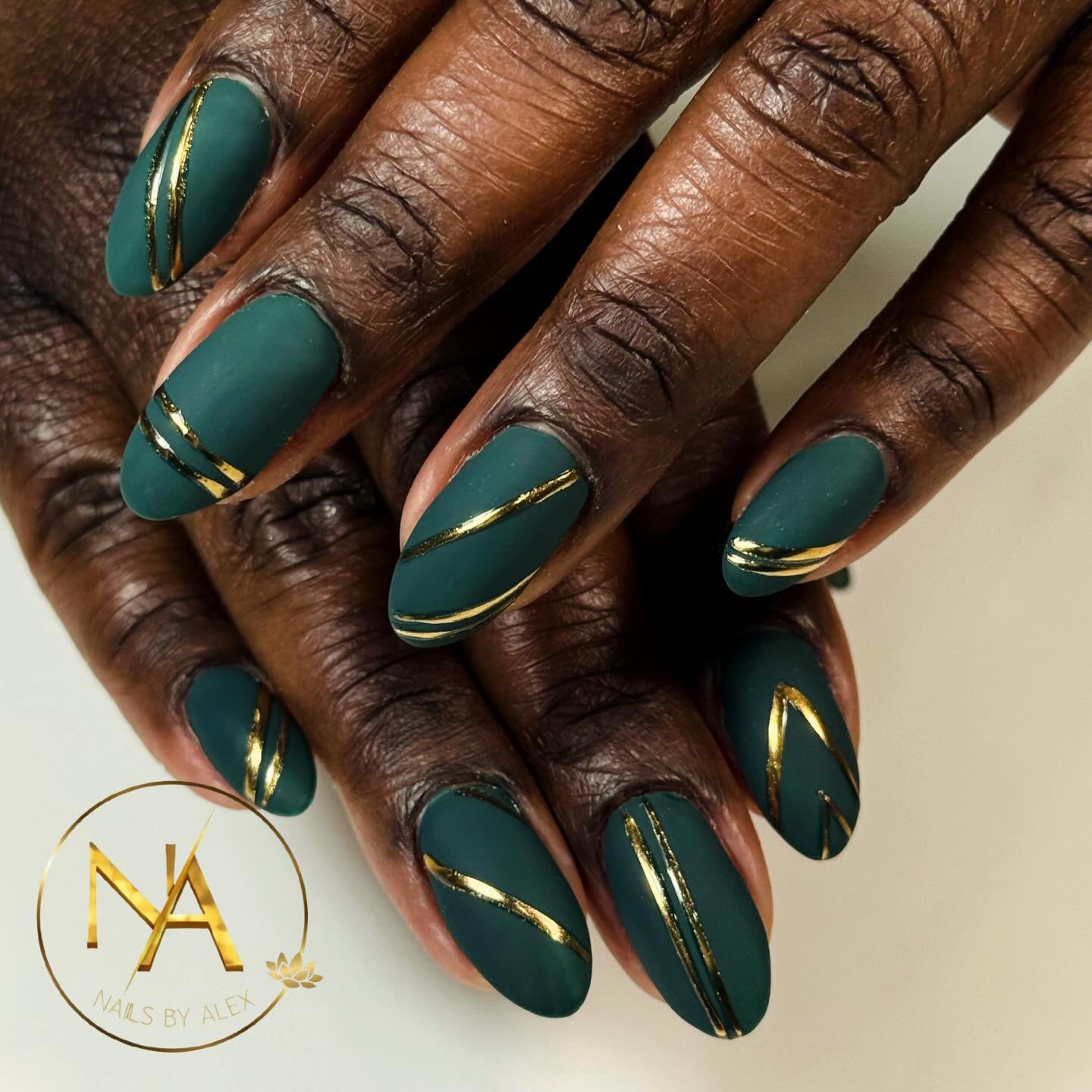 Glossy Green Nails with Fine Gold Swirl Lines