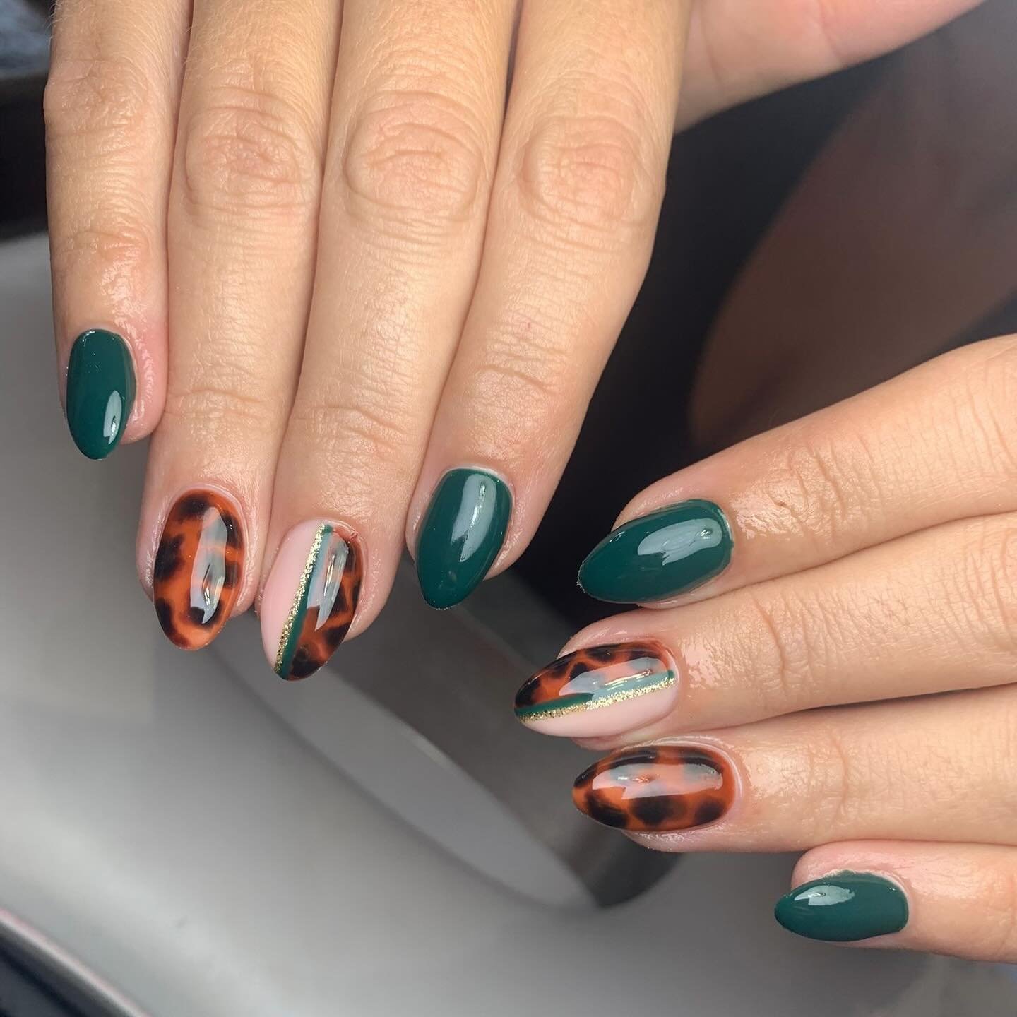 deep green and patterned accent nails