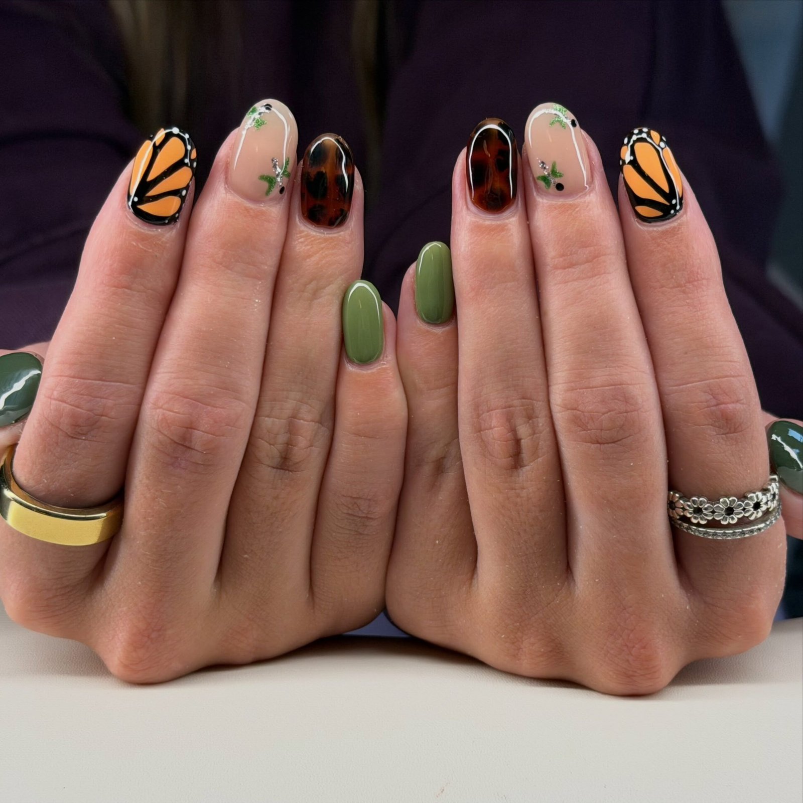 green and brown nails with fine black linework