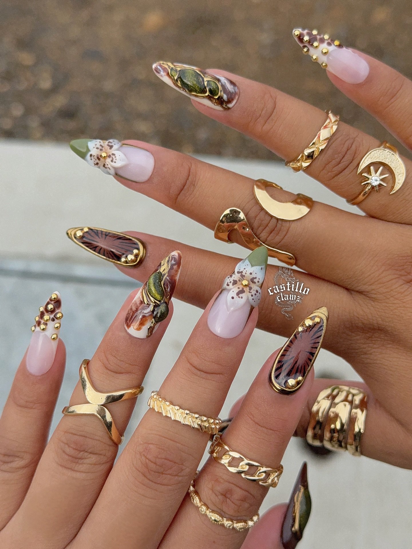 long nude nails with brown  green  and gold details