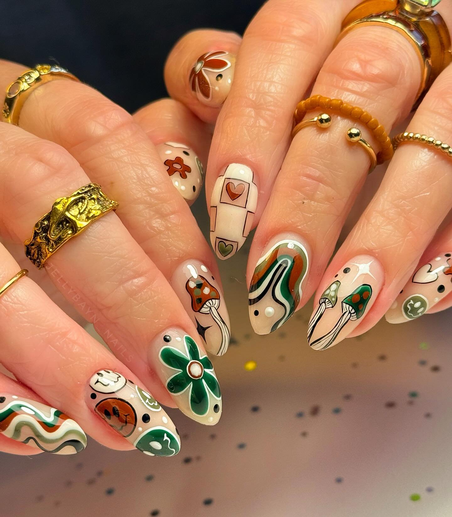 playful green  brown  and nude patterned nails