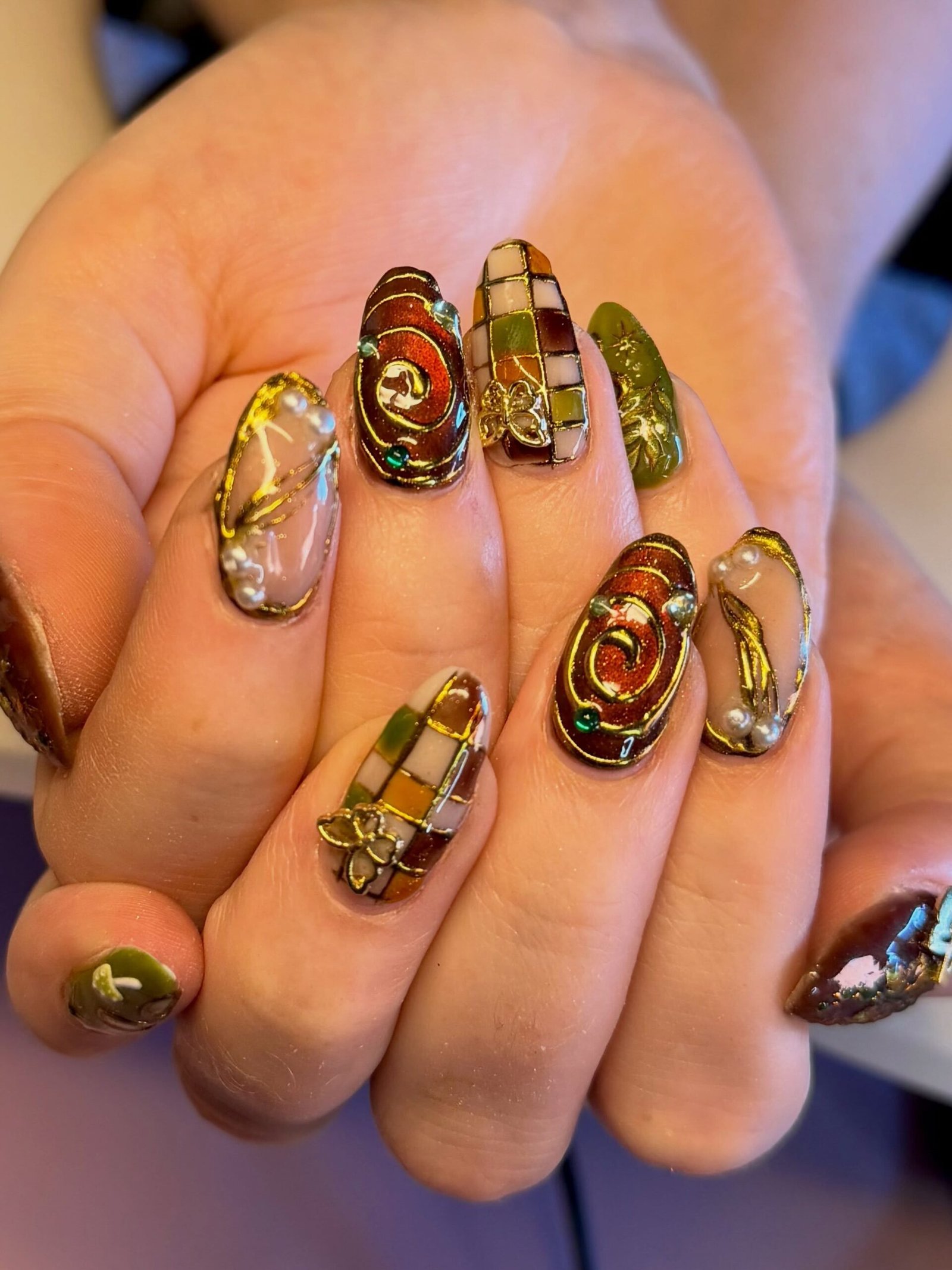 brown and green embellished nail art