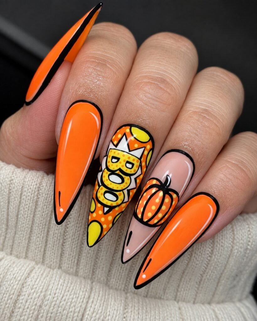 Long bright orange stiletto nails with BOO and pumpkin accents.