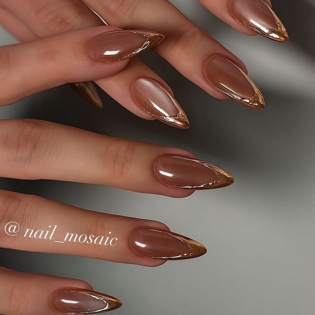 warm brown almond nails with metallic French edges