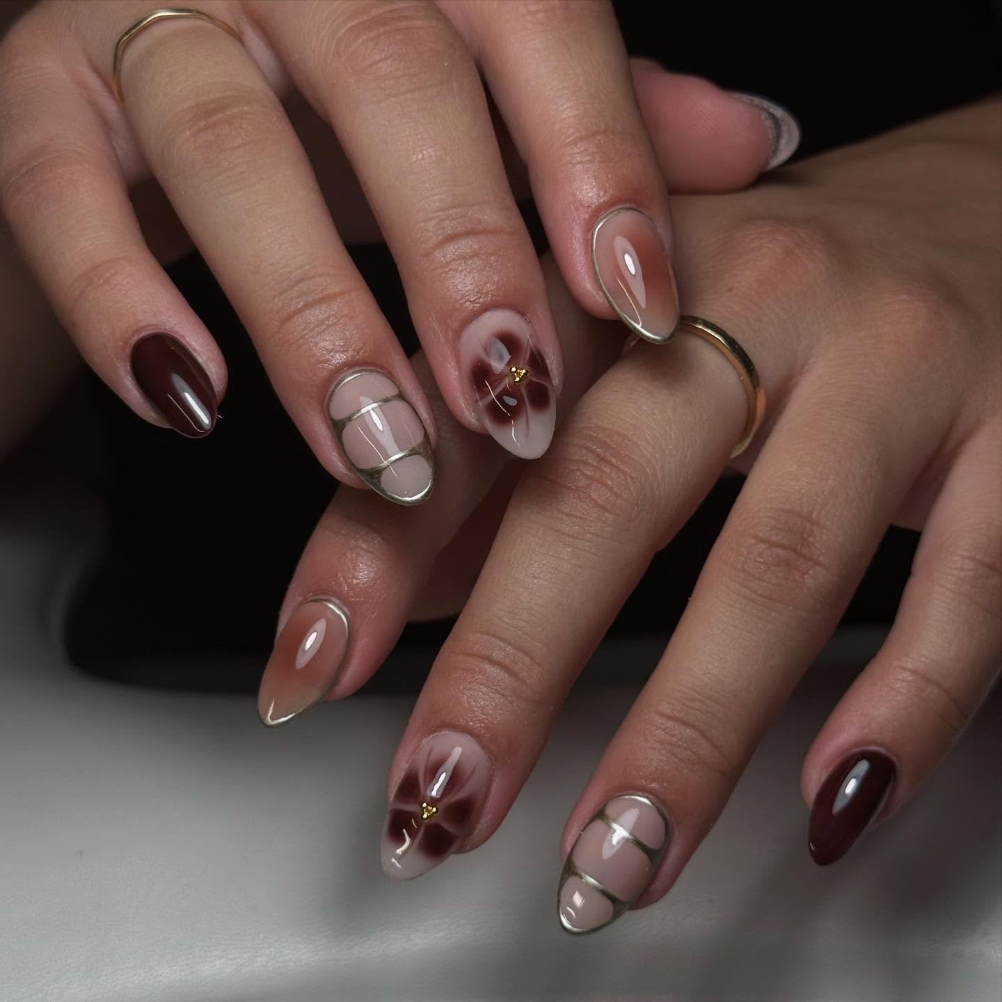 mixed brown and nude almond nails with metallic details