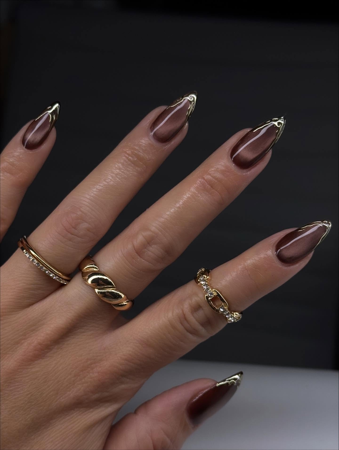 brown almond nails with gold chrome edges