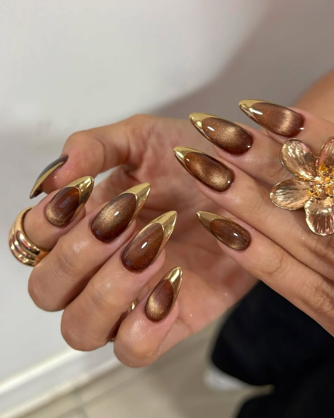 brown almond nails with gold chrome tips
