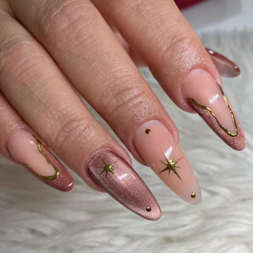 Soft Pink Almond Nails with Gold Outlines and Star Accents