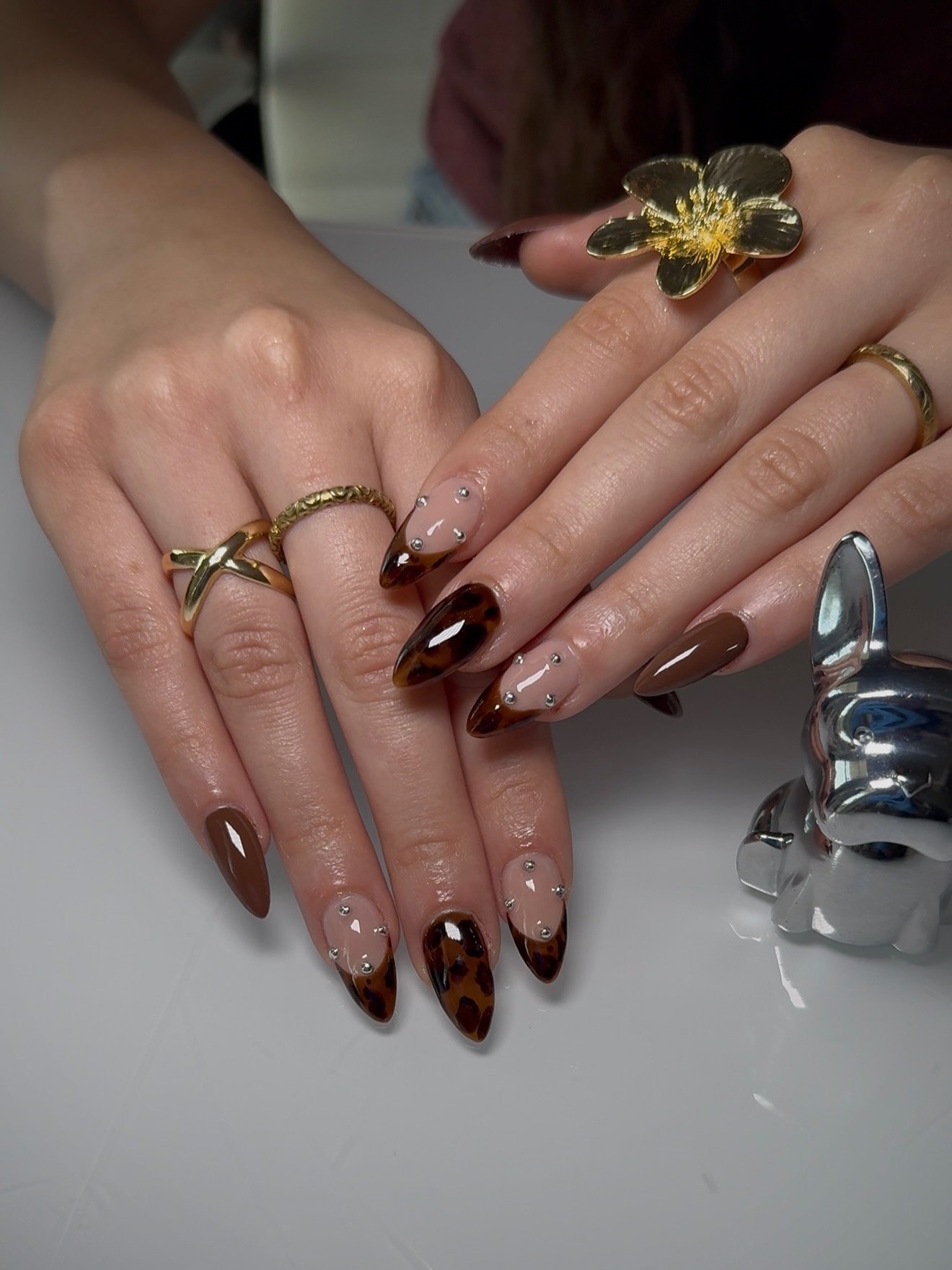 Brown and Nude Almond Nails with Small Gold and Light Accents