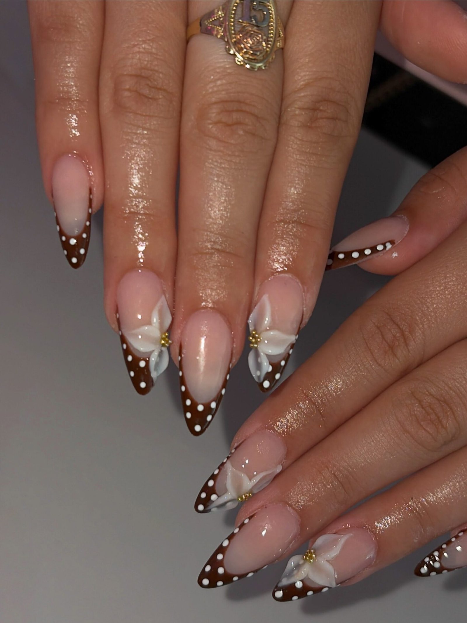 Brown French Almond Nails with White Dots and Floral Accents
