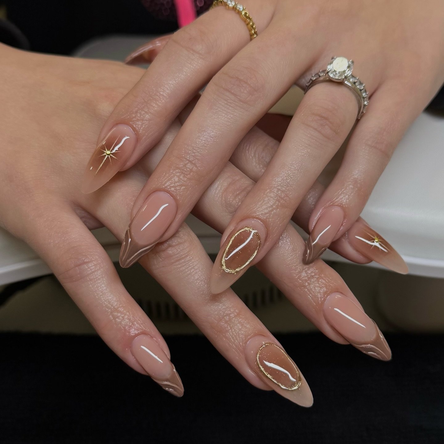 Sheer Nude Almond Nails with Fine Brown and Gold Outlines