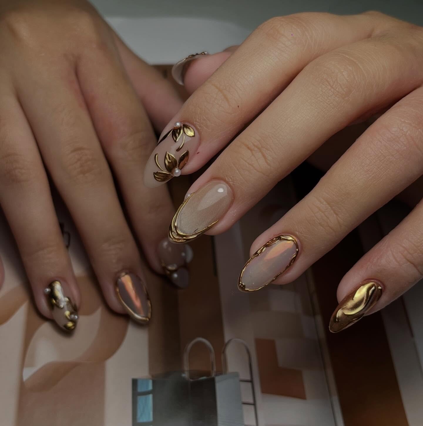 Nude Almond Nails with Brown Details and Gold Embellishments