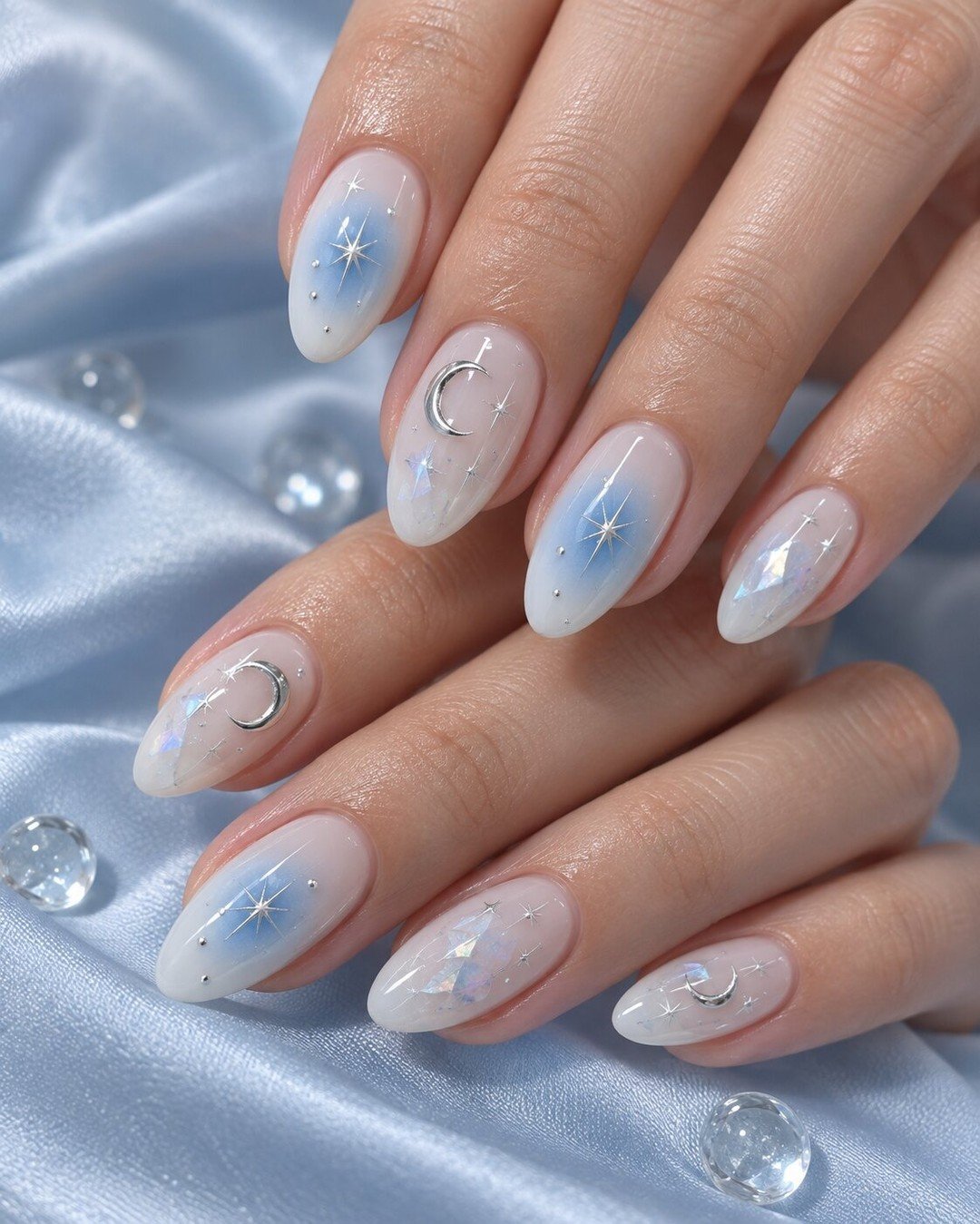 Soft Blue Aura Almond Nails with Delicate Details