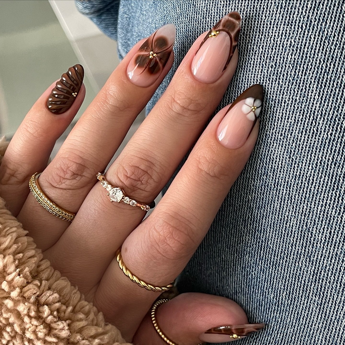 Nude Almond Nails with Brown, Black, and White Mixed Accents