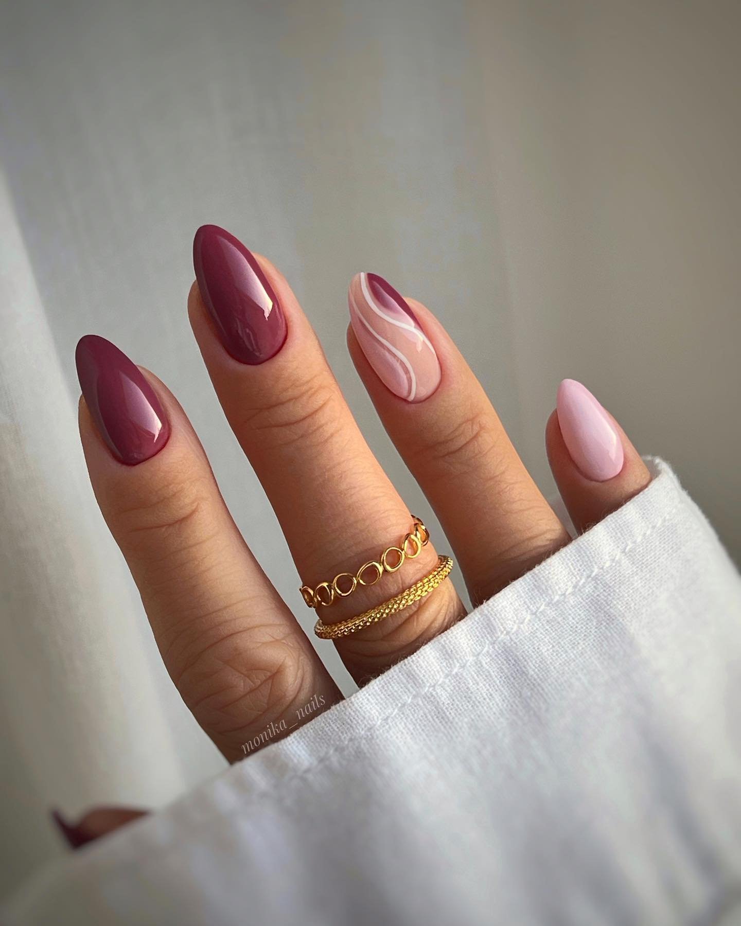 Burgundy and Blush Almond Nails with a Gold Chain Accent