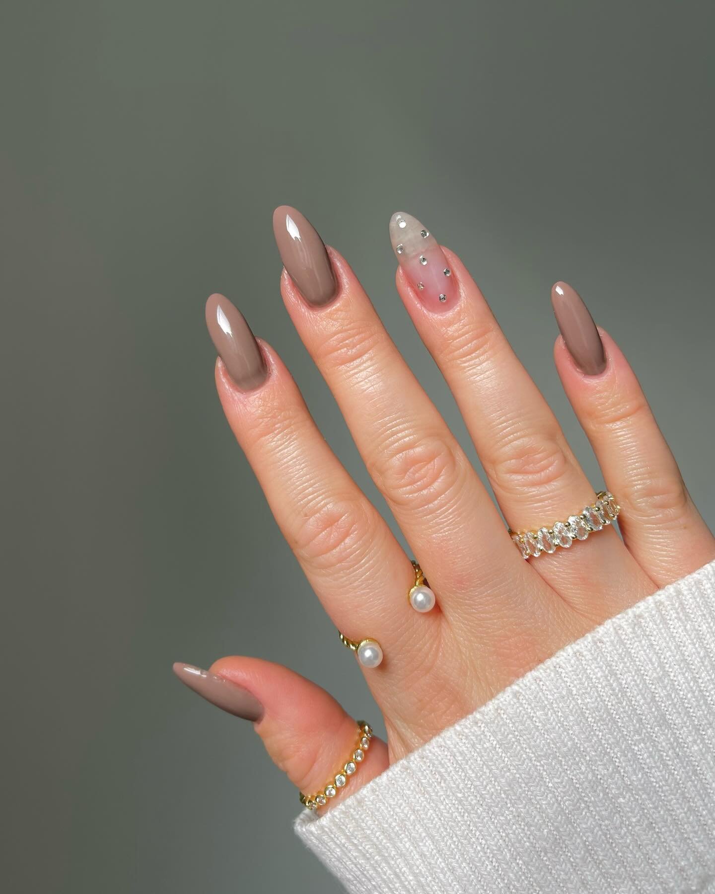 Soft Taupe Almond Nails with Tiny Pearl and Gold Accents