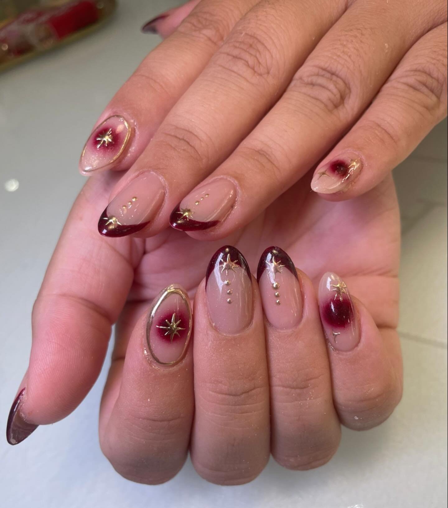Sheer Pink Almond Nails with Tiny Dark and Gold Accents