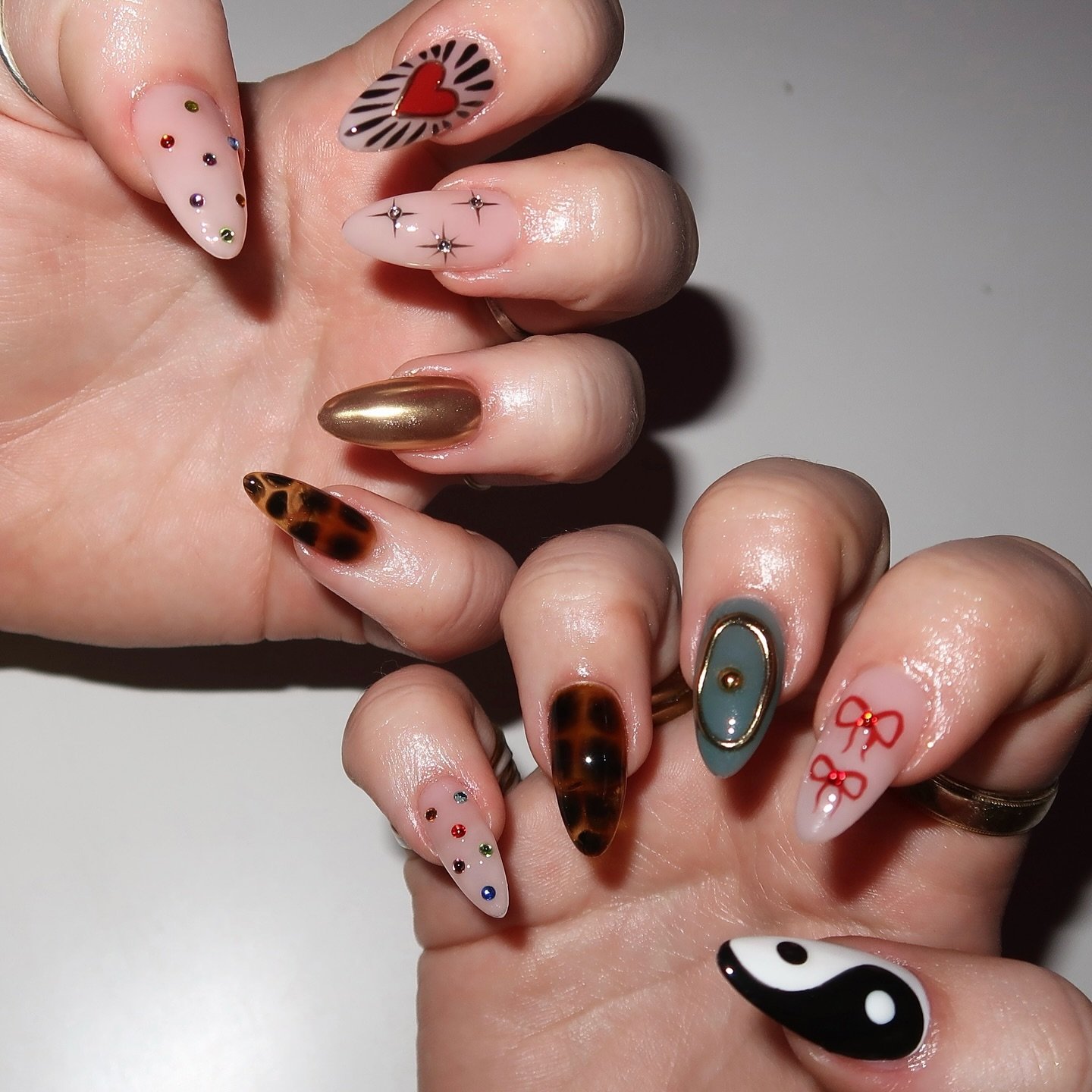 Pink and Brown Nails with Animal-Print and Graphic Accents