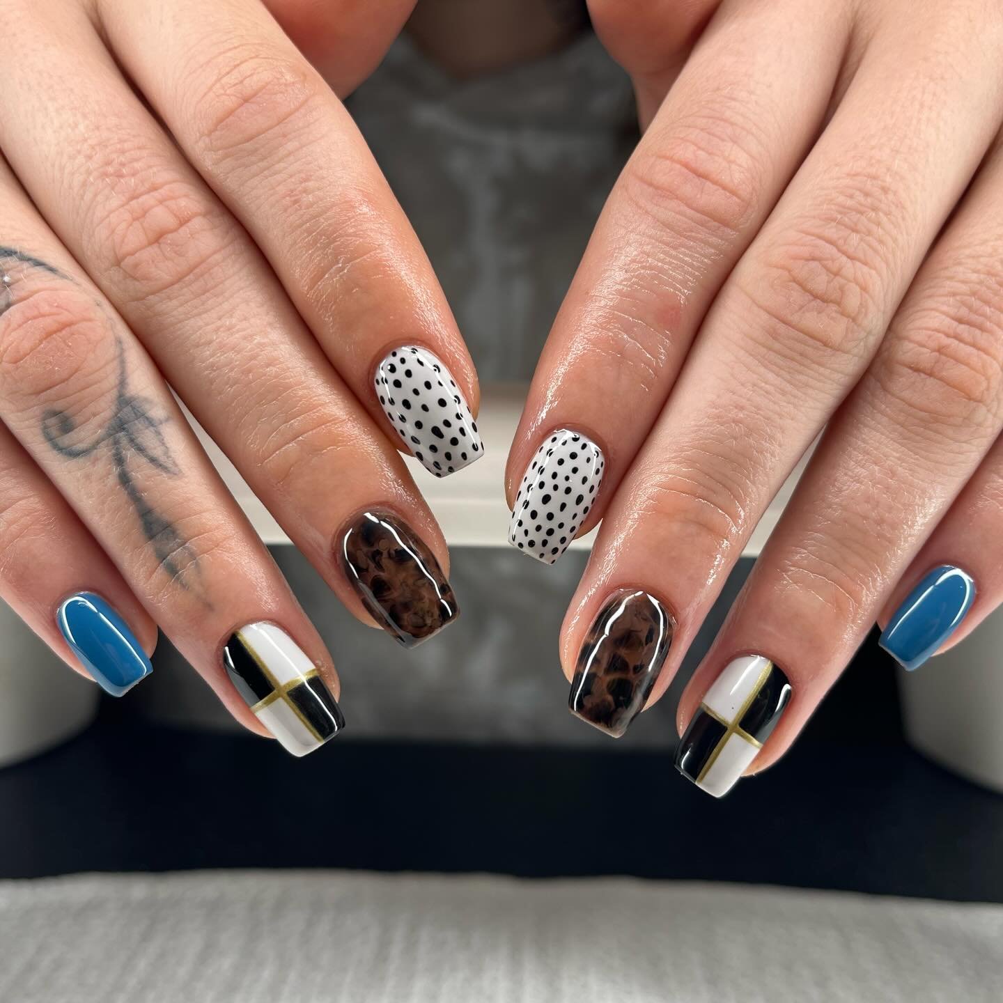 Black, Blue, Nude, and Brown Geometric Almond Nails