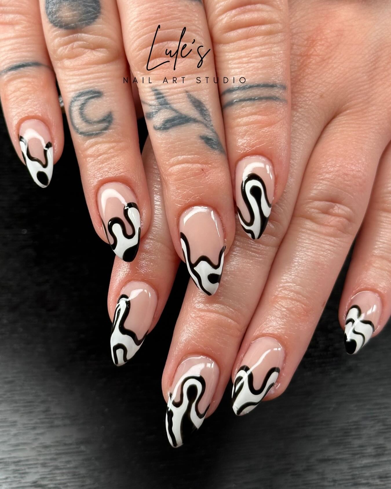 White Almond Nails with Bold Black Abstract Swirls