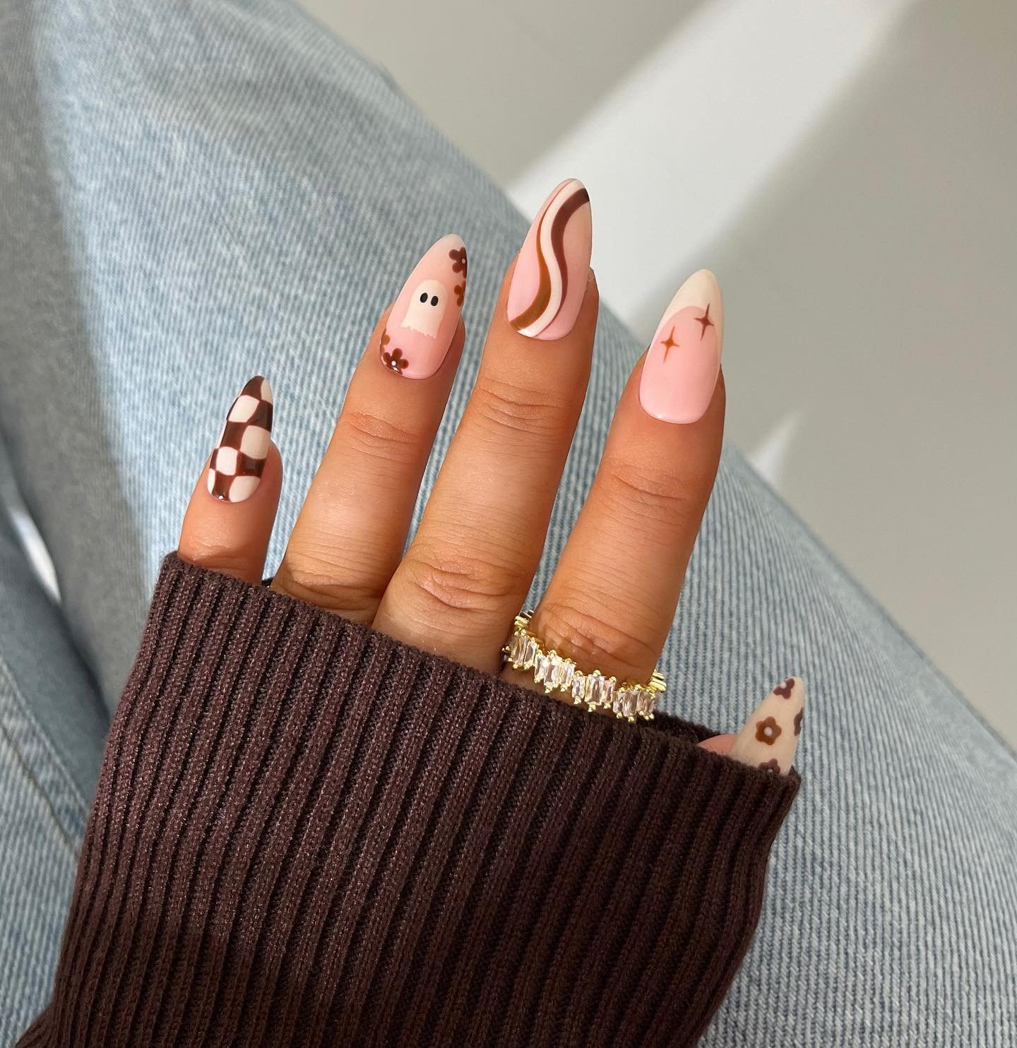 Peachy Nude Almond Nails with Brown Checks and Tiny Dark Motifs
