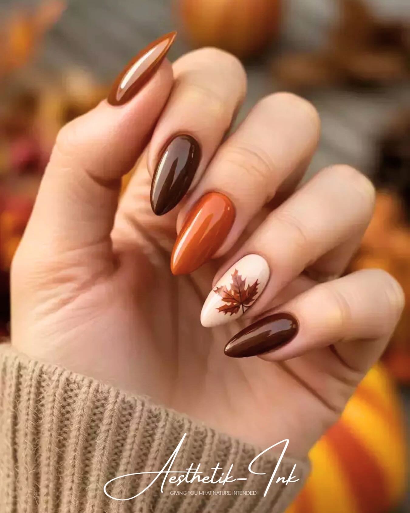 Burnt Orange and Brown Almond Nails with a Leaf Accent