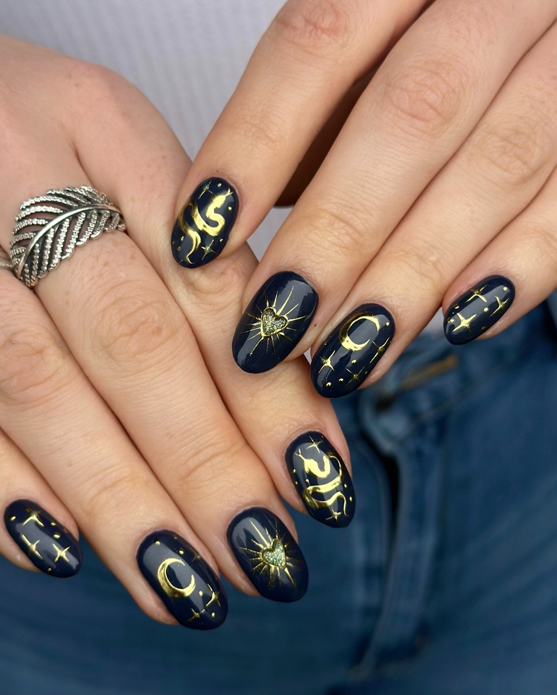 Short Oval Nails with Black and Gold Accents
