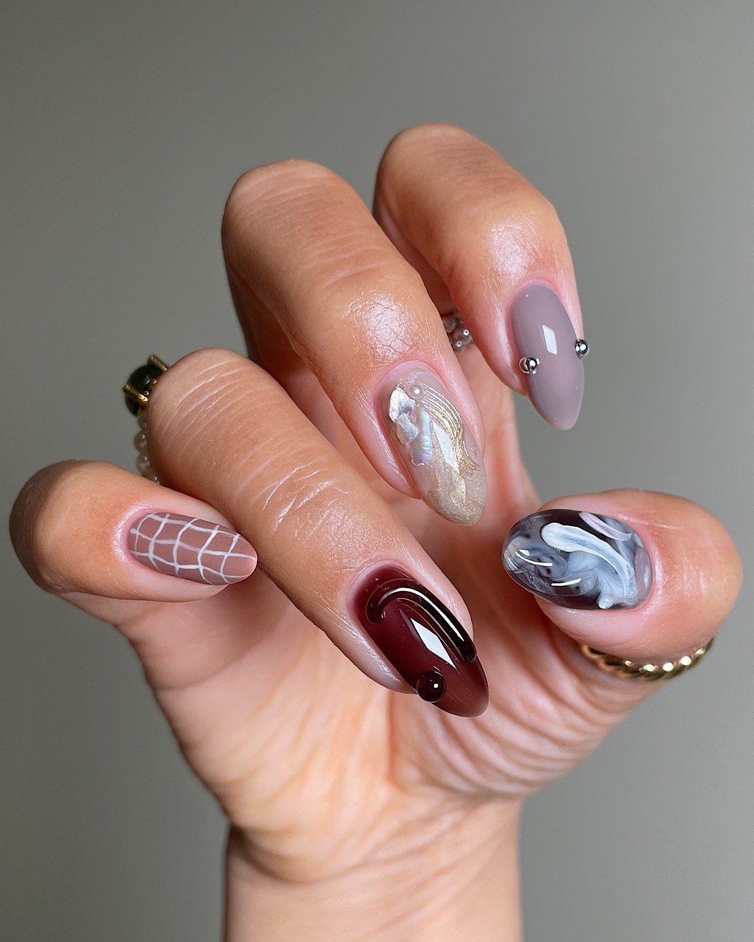 Mixed Brown Almond Nails with Marbled and Line Details