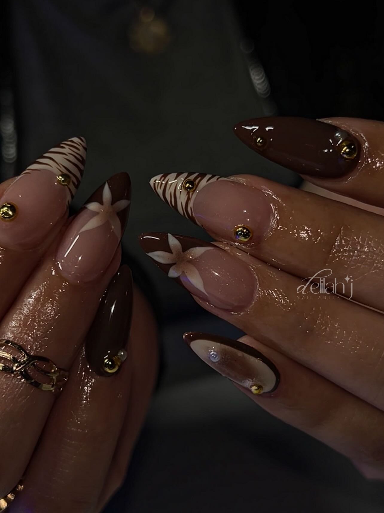 Dark Brown Almond Nails with Gold and Light Accents