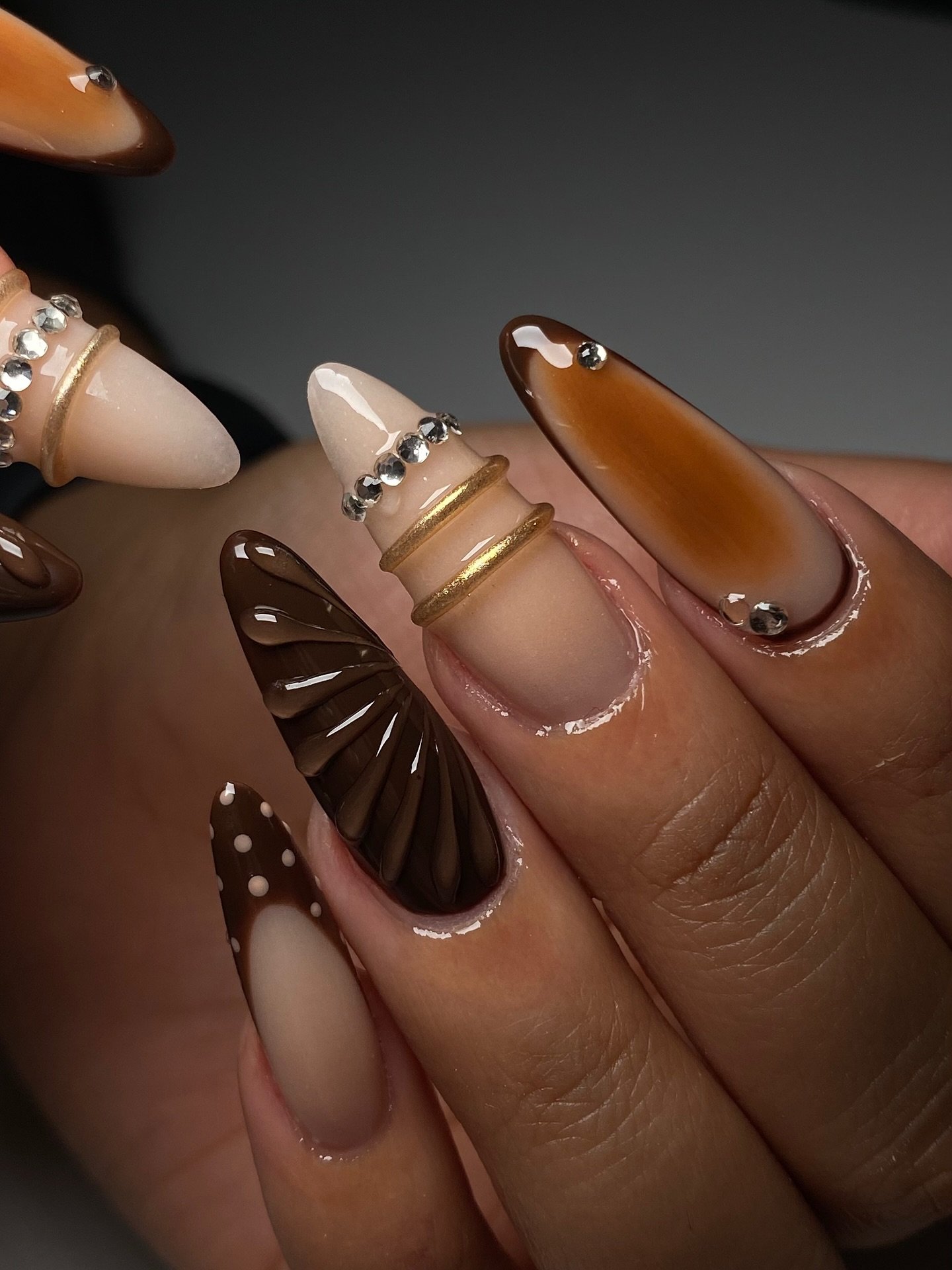 Glossy Brown Almond Nails with Gold Outlining
