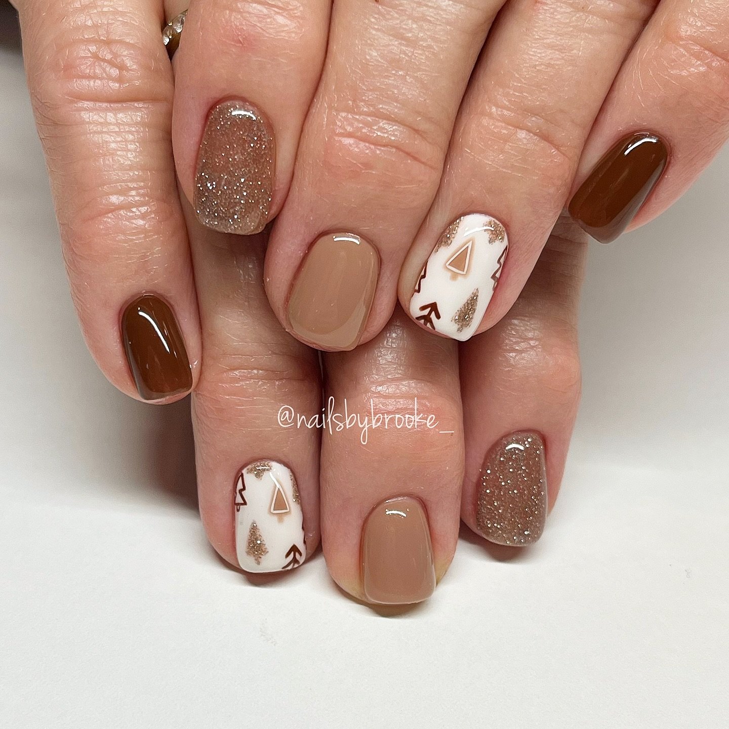 Neutral Brown Nails with Glitter and White Accents