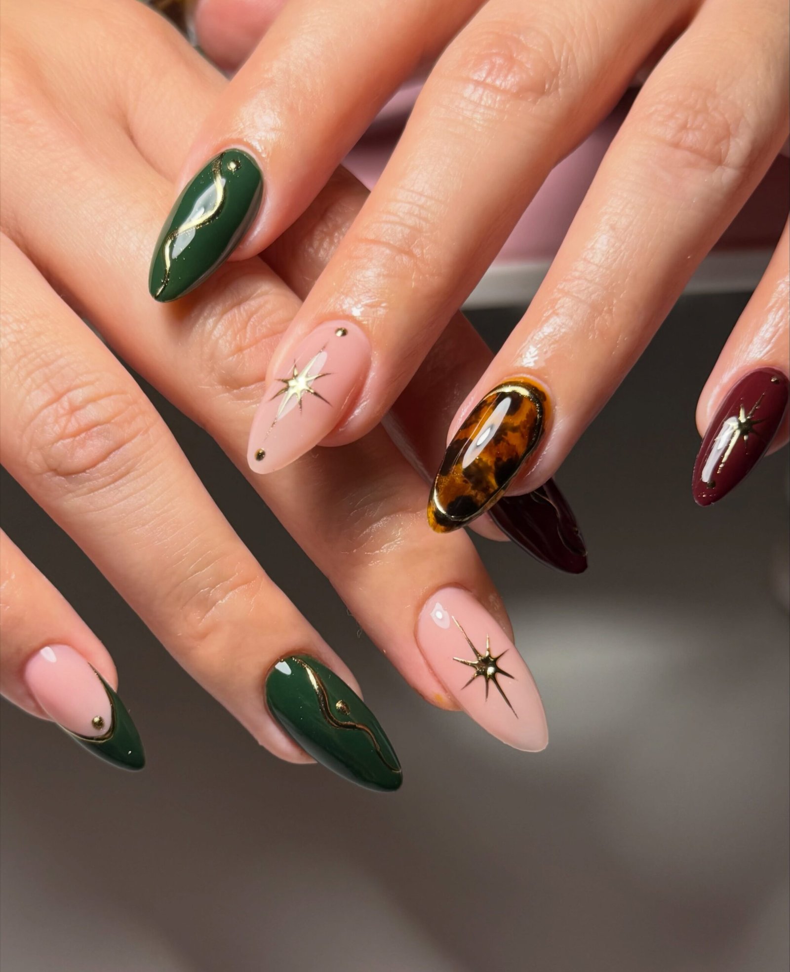 Green, Burgundy, and Brown Almond Nails with Gold Details