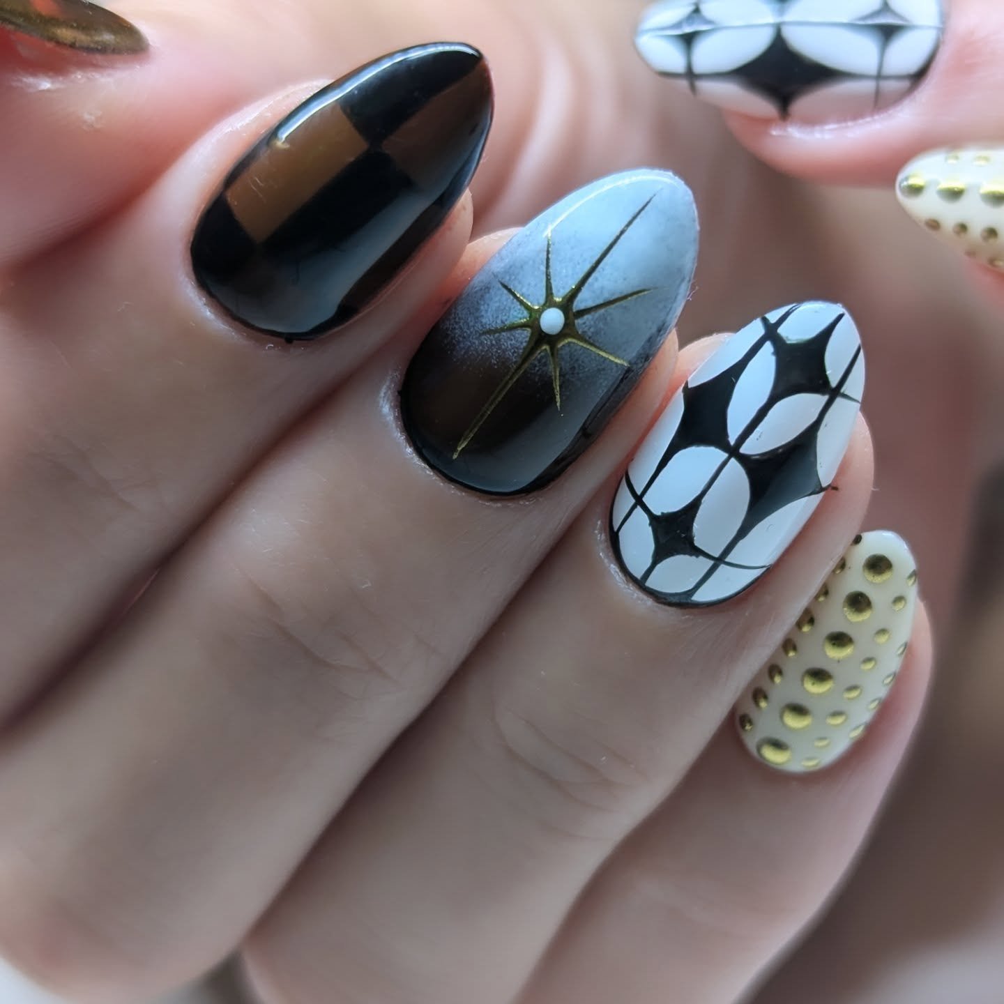 Black Graphic Nails with Blue, Orange, and Red Details