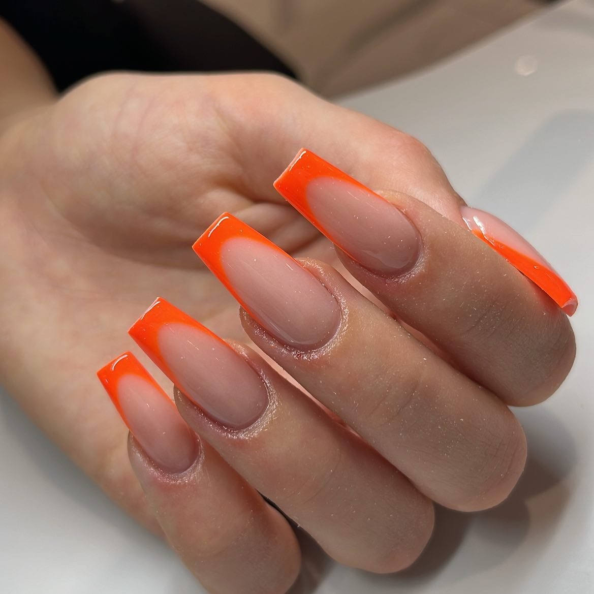 Clean Neon Orange French Tips on a Nude Base nail design