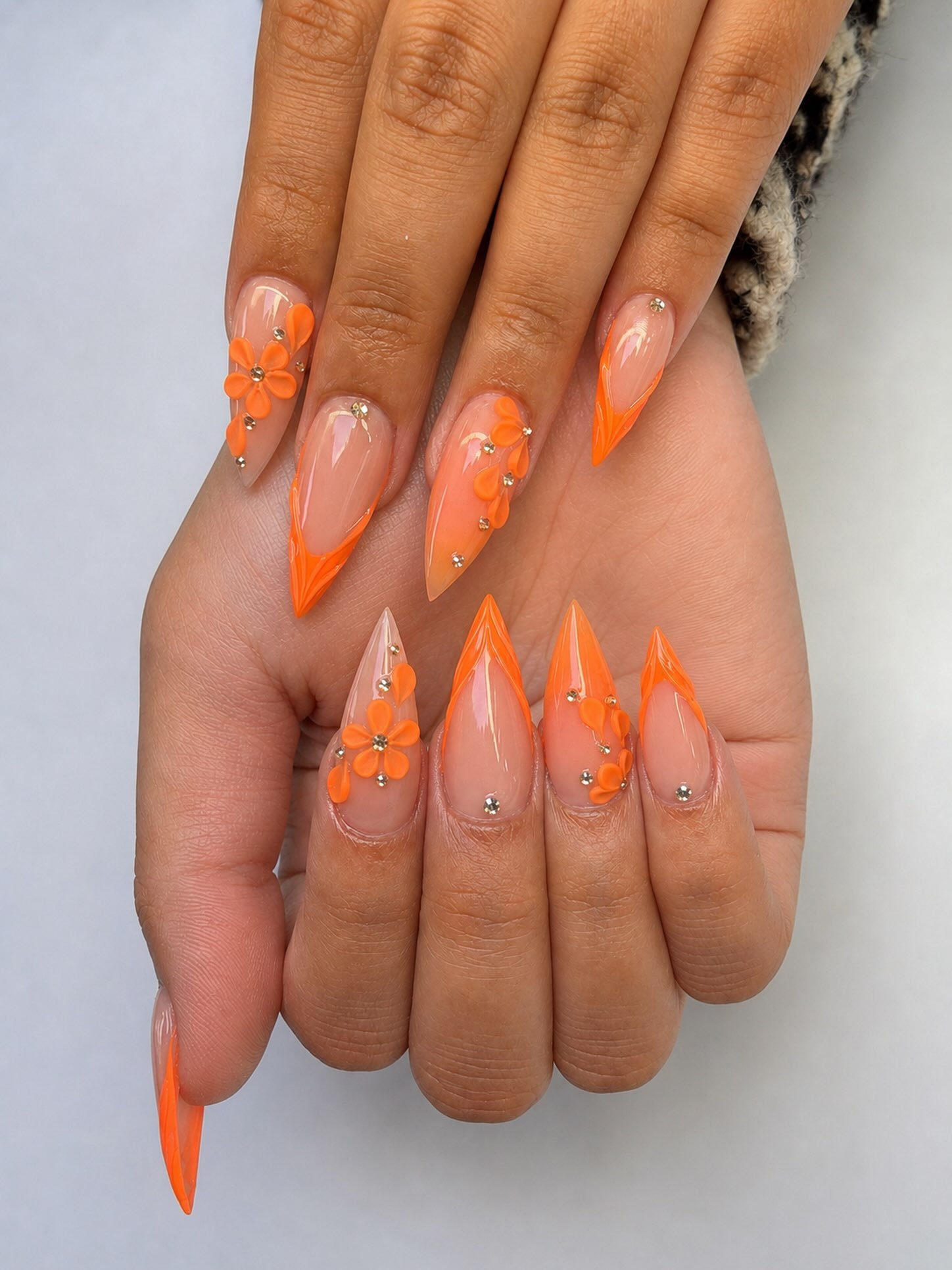 Pointed Orange French Tips with Raised Orange Details nail design