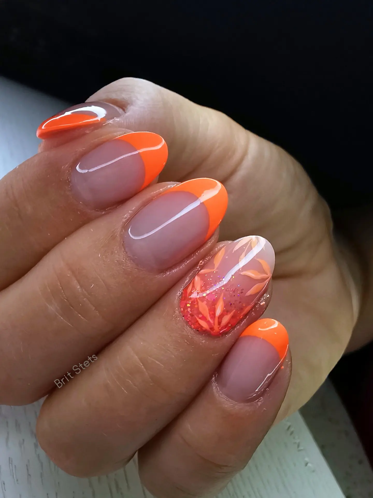 Orange French Tips with a Marble Accent nail design