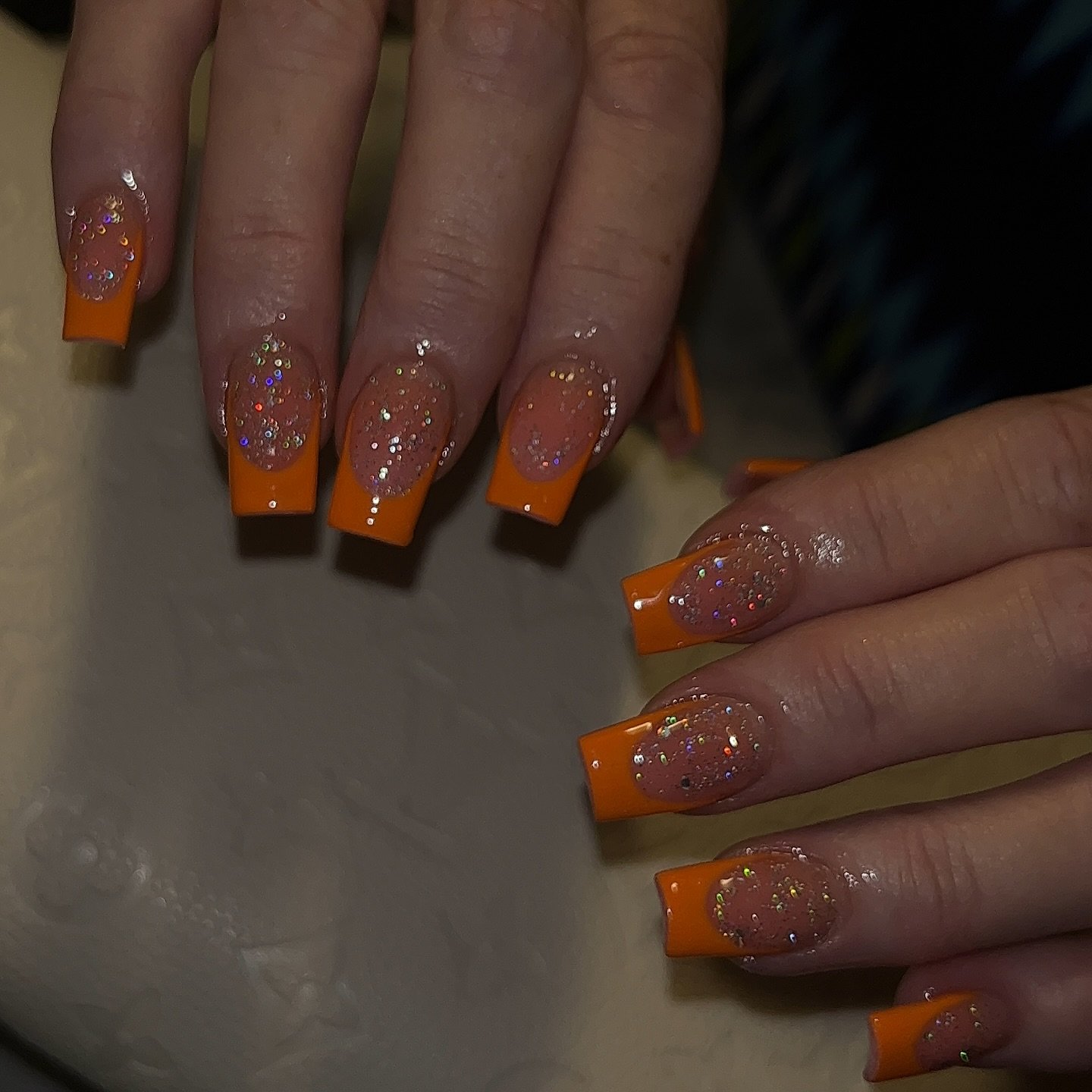 Orange French Tips with Raised Yellow Floral Embellishments nail design