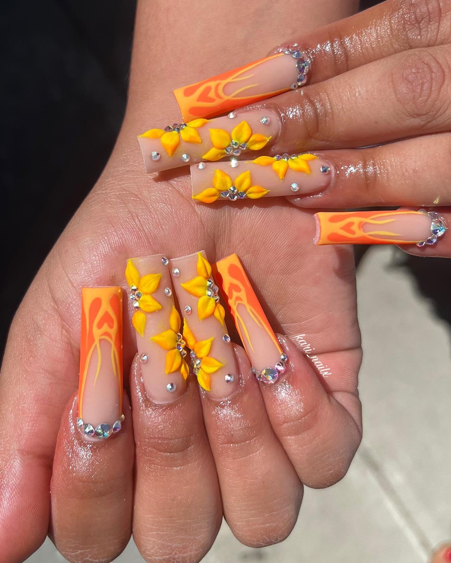Orange French Tips with Orange Sunburst Accents nail design
