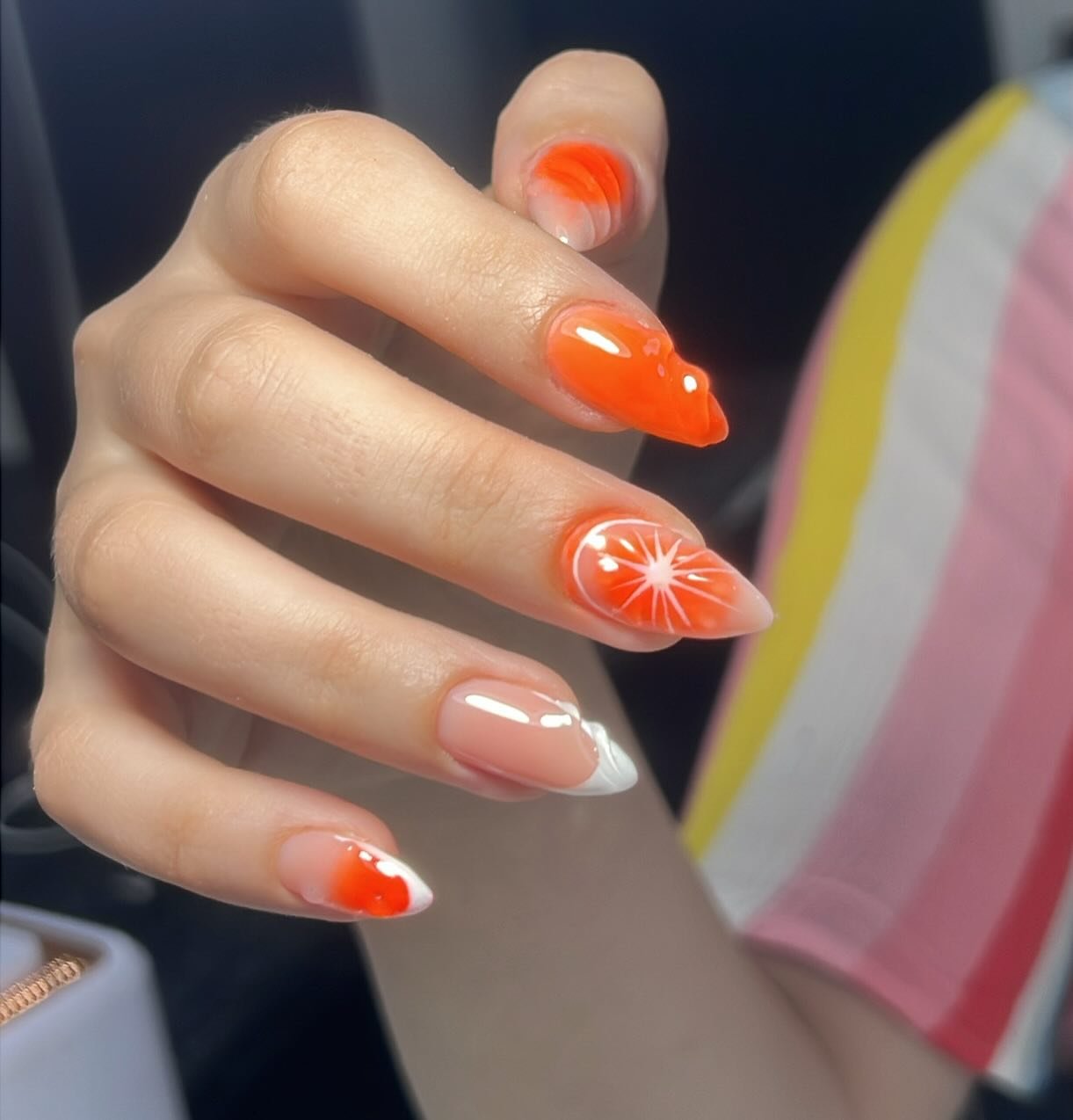 Orange French Tips with White Sunburst Accents nail design