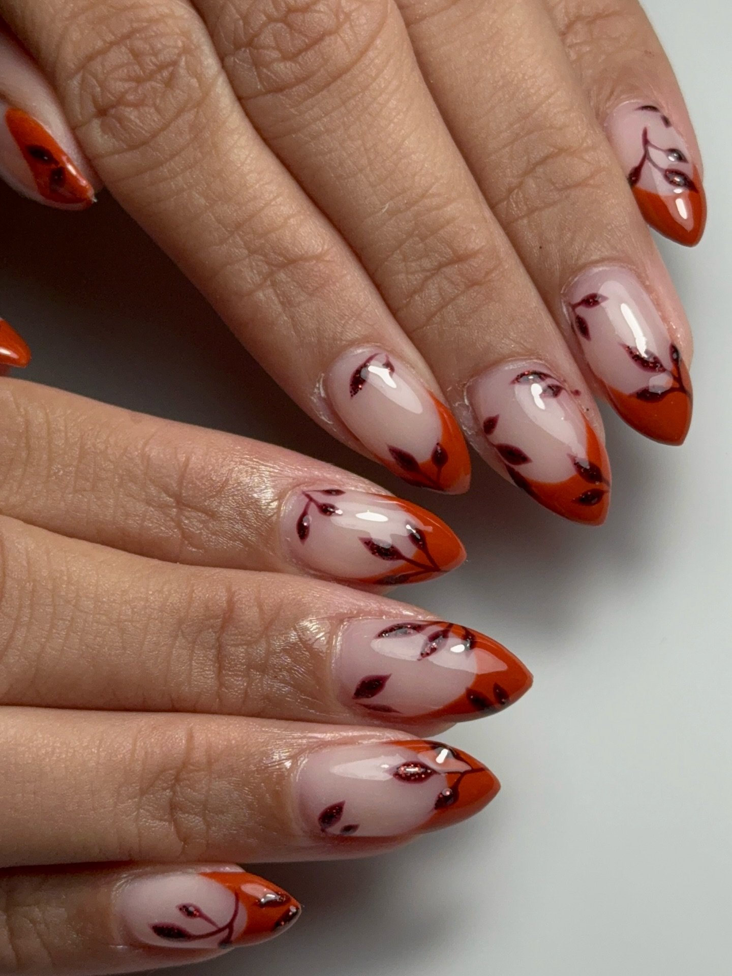 Orange French Tips with Red-and-Black Floral Line Art nail design