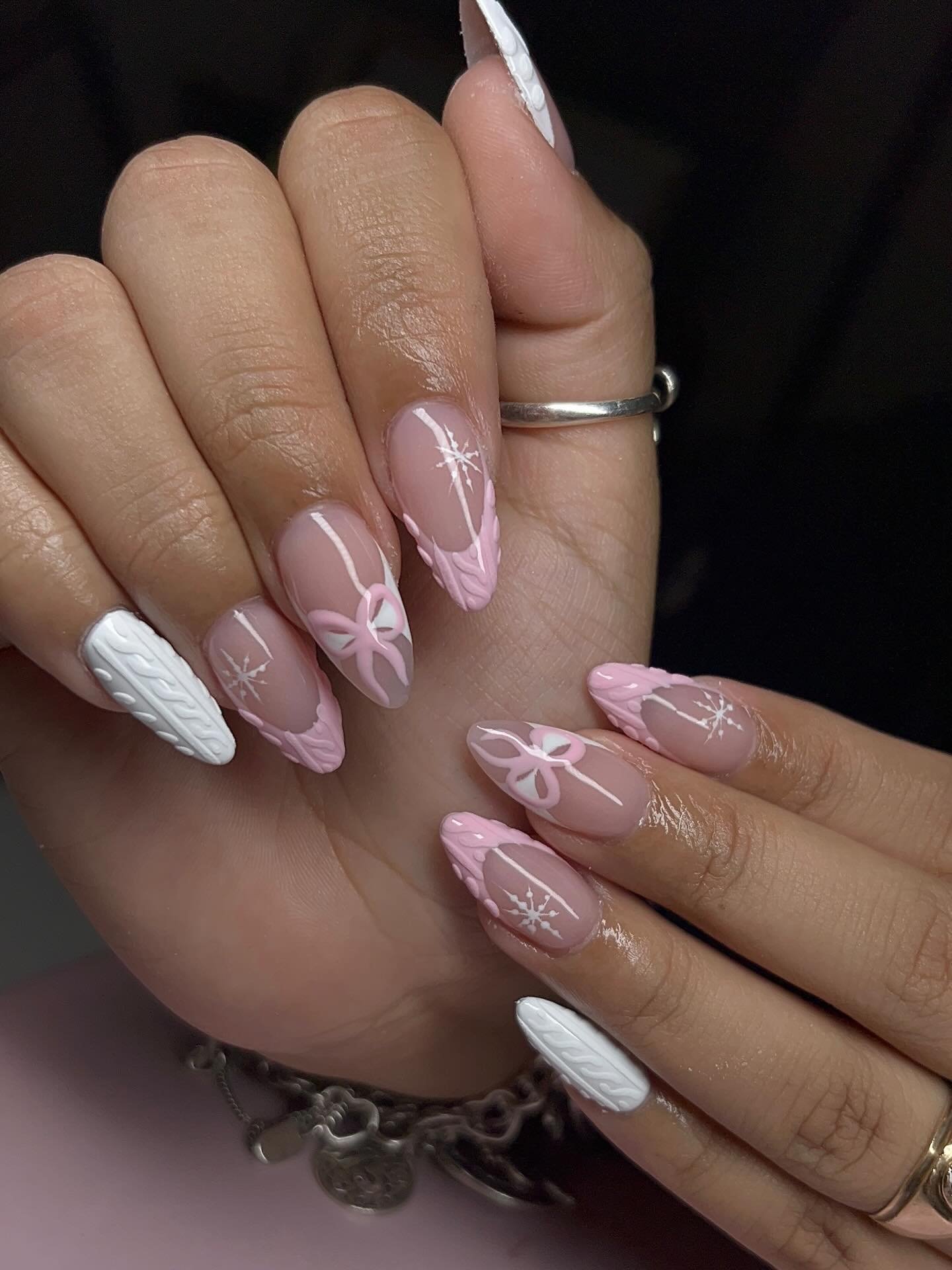Pink Almond Nails with White Snowflakes and Bow Details
