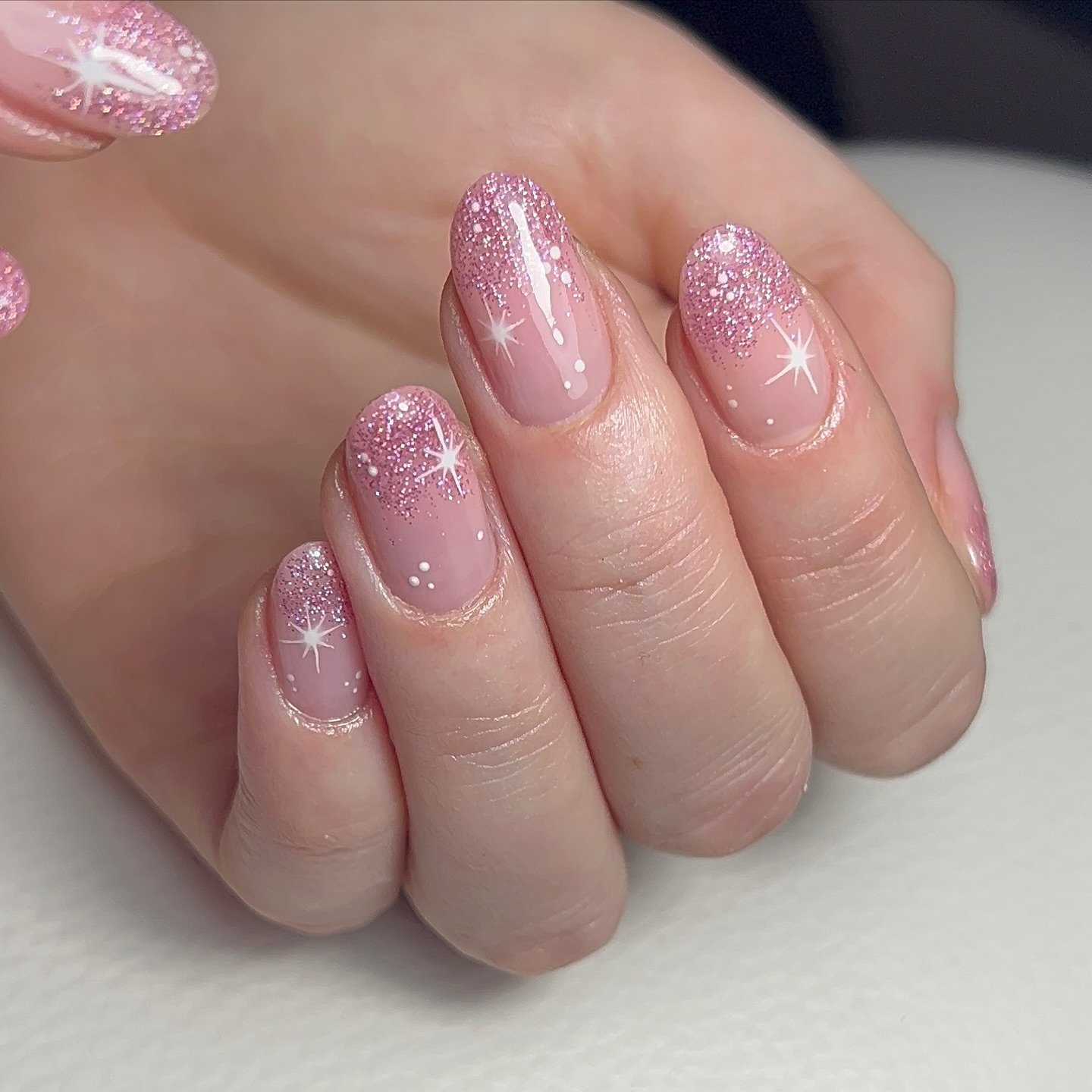 Short Pink Nails with Glitter and Snowflake Accents