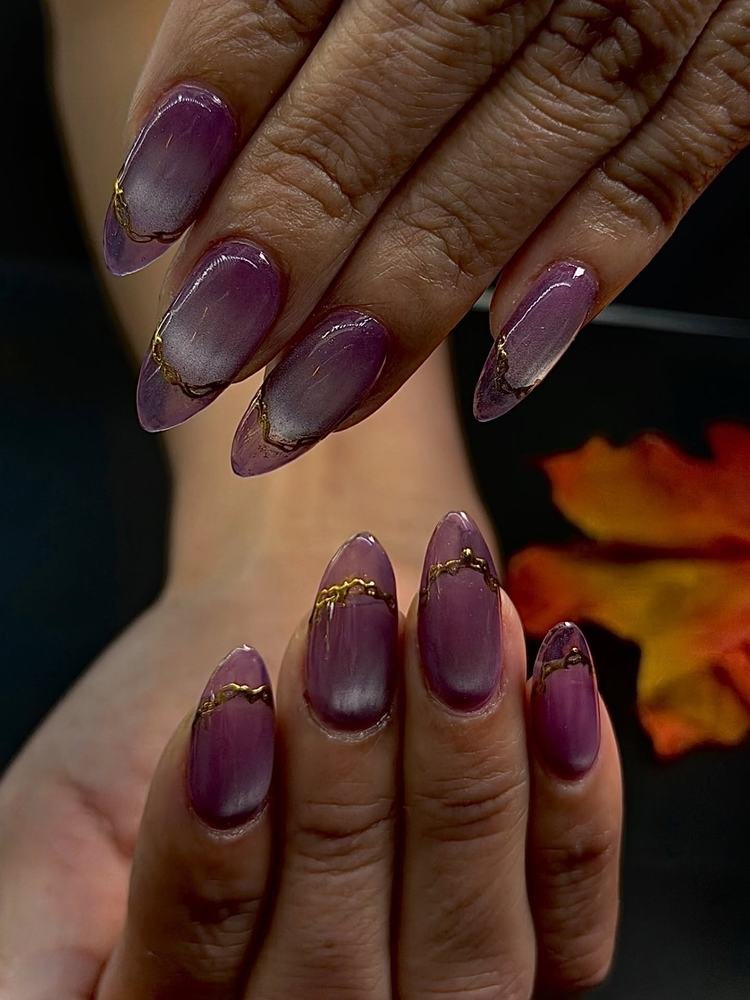 Glossy Plum Nails with Gold Edges and Pink Accents