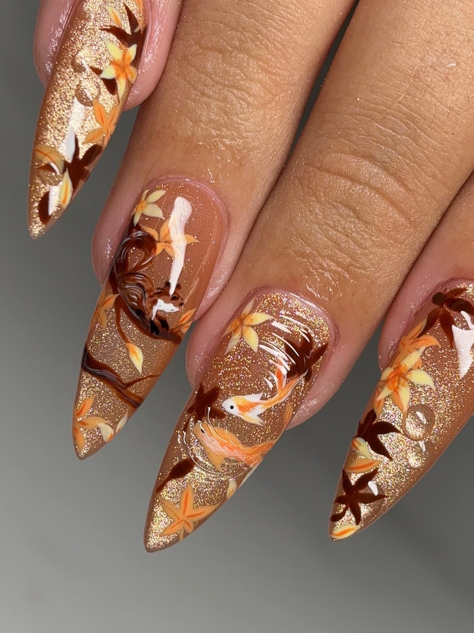 Long Orange Tortoiseshell Stiletto Nails with Gold Line Art