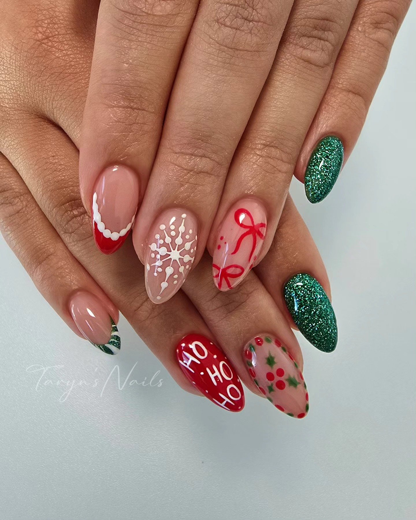Red and Green Holiday Nails with Snowflakes and a Bow