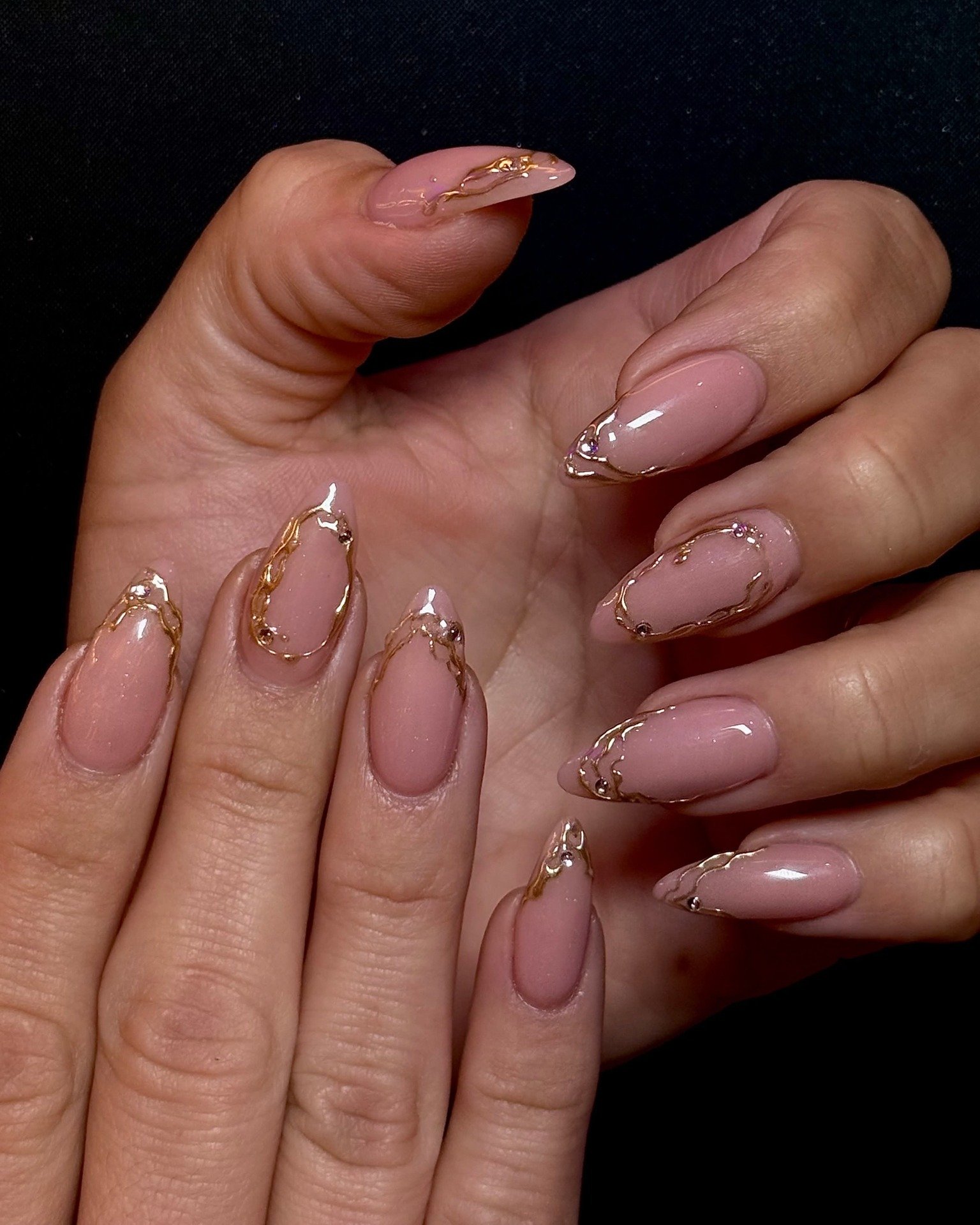Blush Pink Almond Nails with Delicate Gold-Tone Details